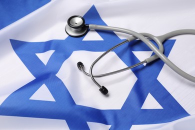 Photo of Stethoscope on flag of Israel. Health care concept