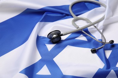 Stethoscope on flag of Israel, closeup. Health care concept