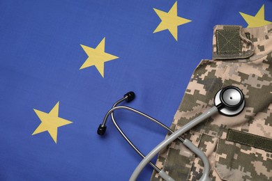 Photo of Stethoscope and military uniform on flag of European Union, top view