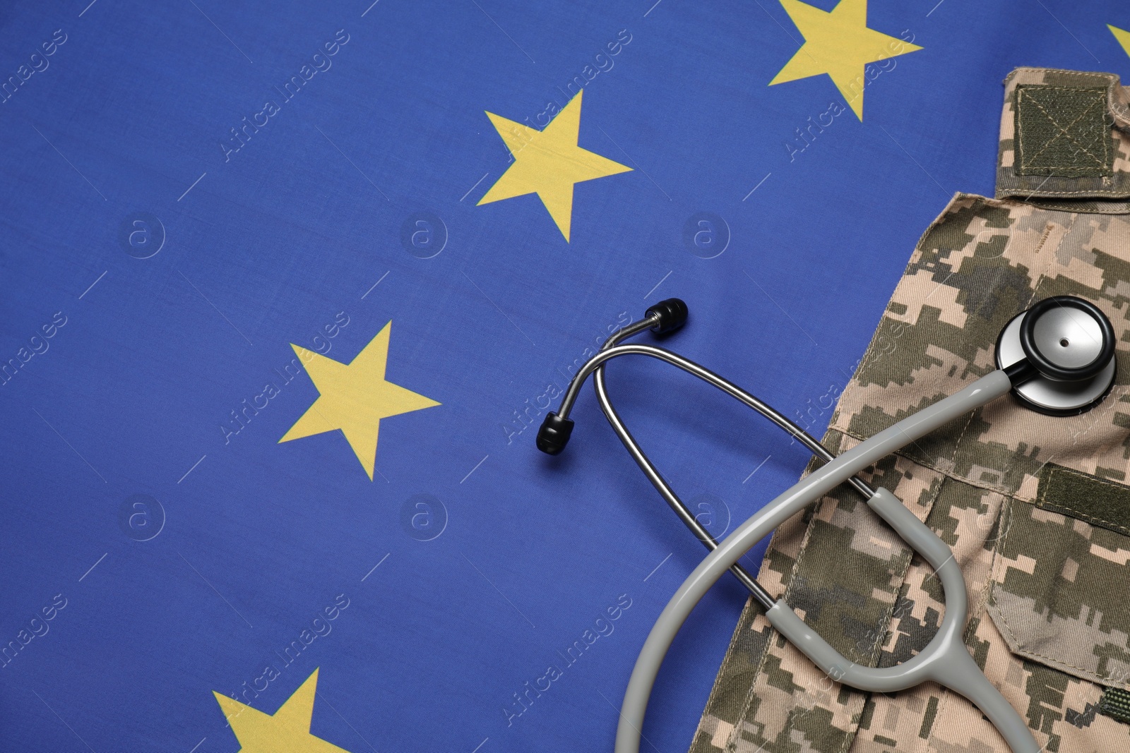 Photo of Stethoscope and military uniform on flag of European Union, top view