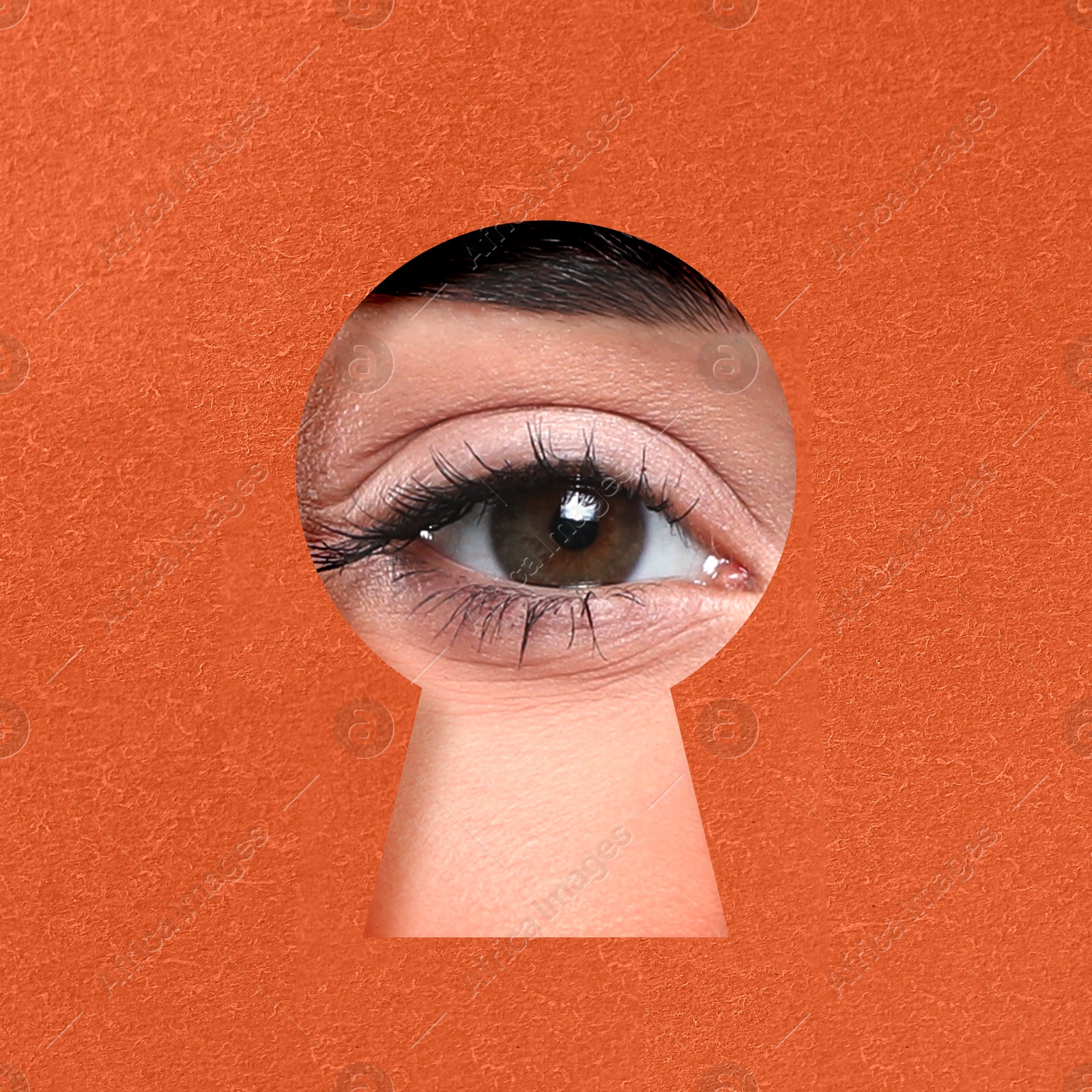 Image of Woman looking through keyhole in dark orange surface