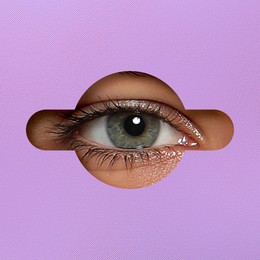 Woman looking through keyhole in violet surface