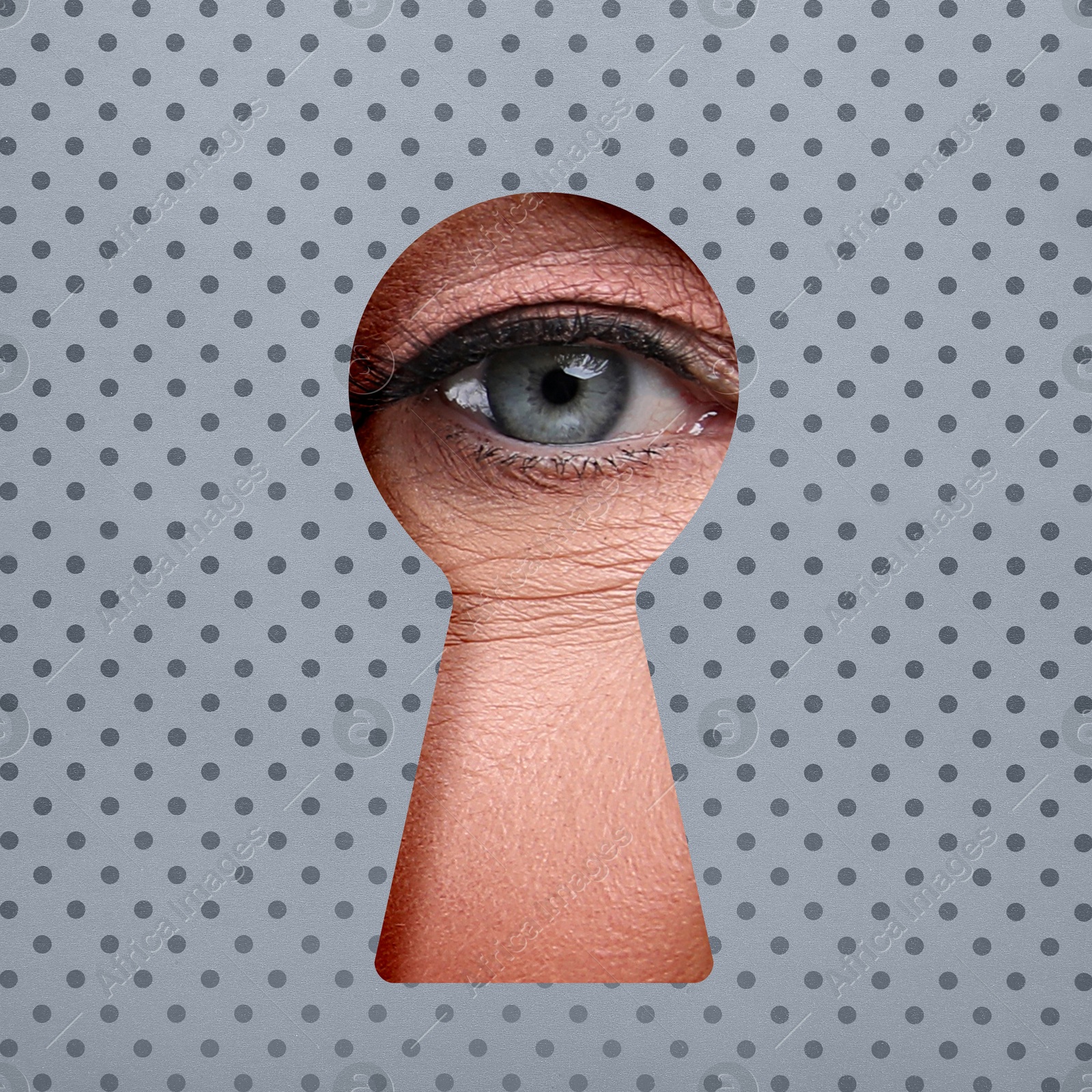 Image of Woman looking through keyhole in grey dotted surface