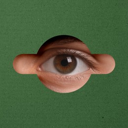 Image of Man looking through keyhole in green surface
