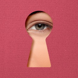 Image of Woman looking through keyhole in crimson color surface