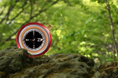 Image of Navigational instrument. Compass in forest, closeup. Space for text