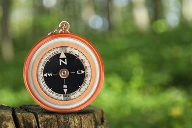 Navigational instrument. Compass in forest, closeup. Space for text