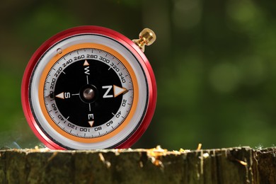 Navigational instrument. Compass outdoors, closeup. Space for text