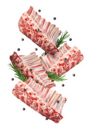 Image of Raw ribs, rosemary and peppercorns in air isolated on white