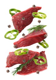 Image of Pieces of raw beef meat, pepper slices, rosemary and peppercorns in air isolated on white