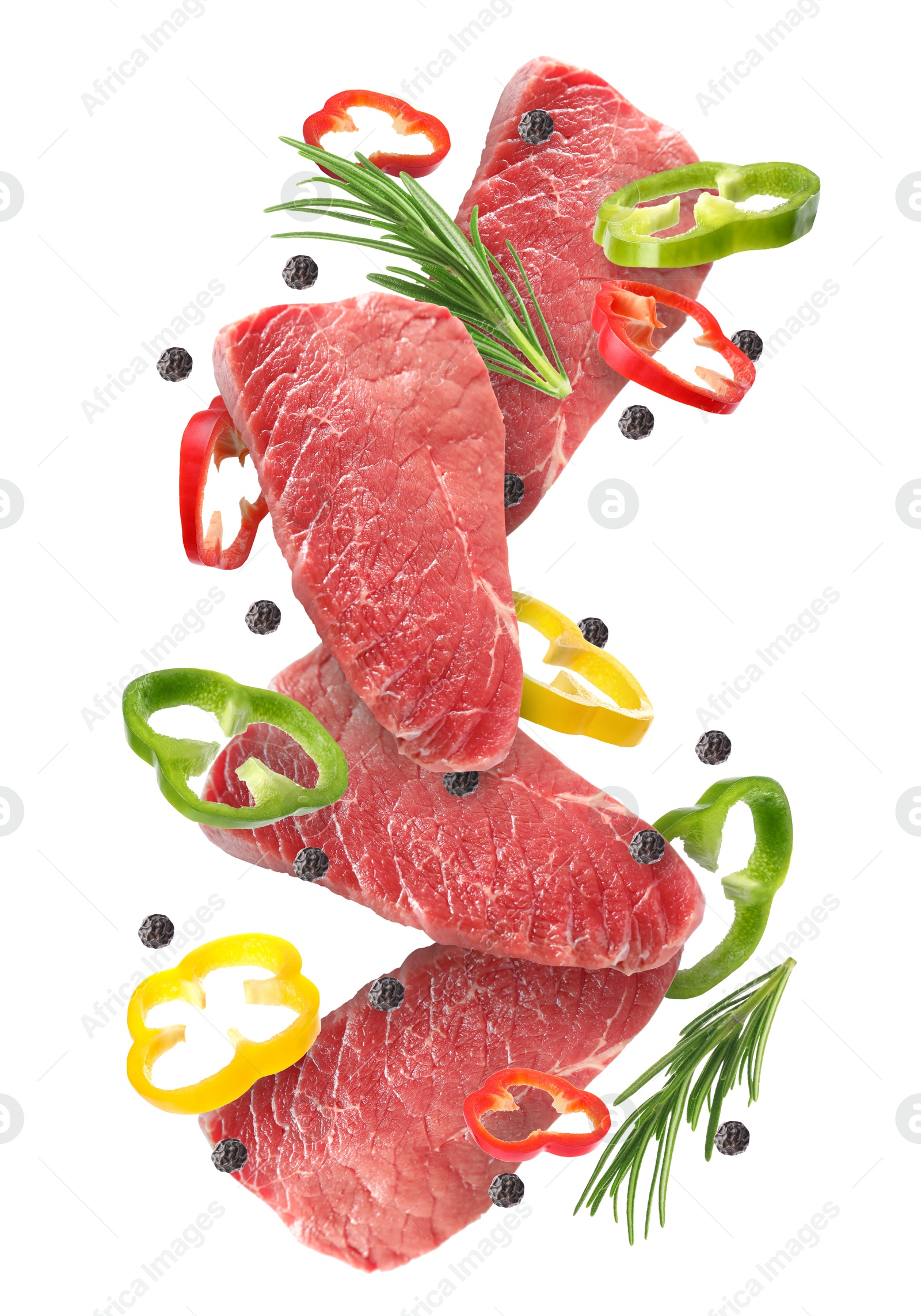 Image of Pieces of raw beef meat, pepper slices, rosemary and peppercorns in air isolated on white