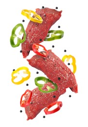 Image of Pieces of raw beef meat, pepper slices and peppercorns in air isolated on white