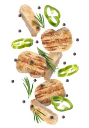 Image of Pieces of grilled chicken meat, pepper slices, rosemary and peppercorns in air isolated on white