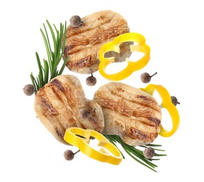 Image of Pieces of grilled chicken meat, pepper slices, rosemary and peppercorns in air isolated on white