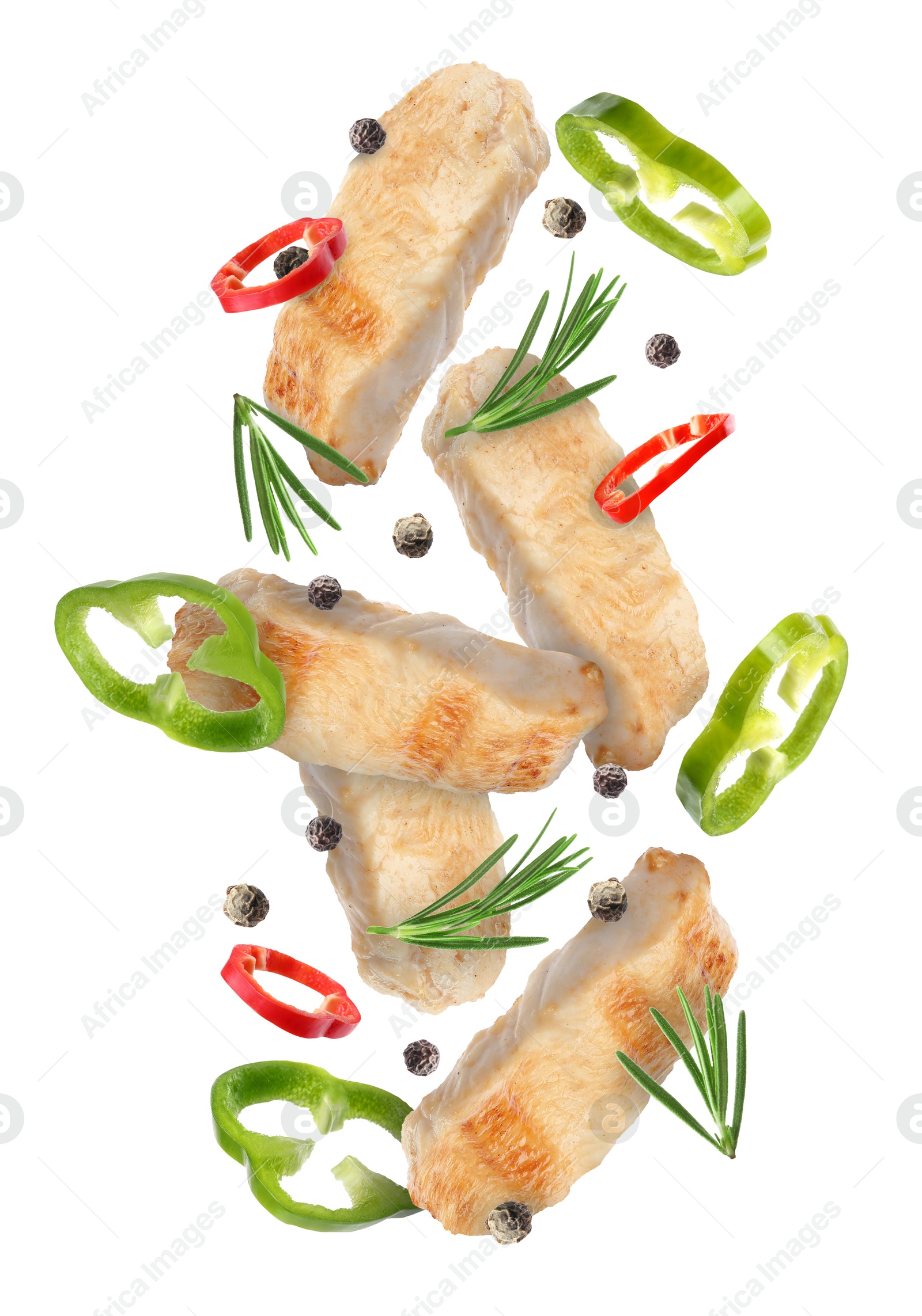 Image of Pieces of grilled chicken meat, pepper slices, rosemary and peppercorns in air isolated on white