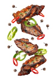 Image of Grilled beef ribs, pepper slices and peppercorns in air isolated on white