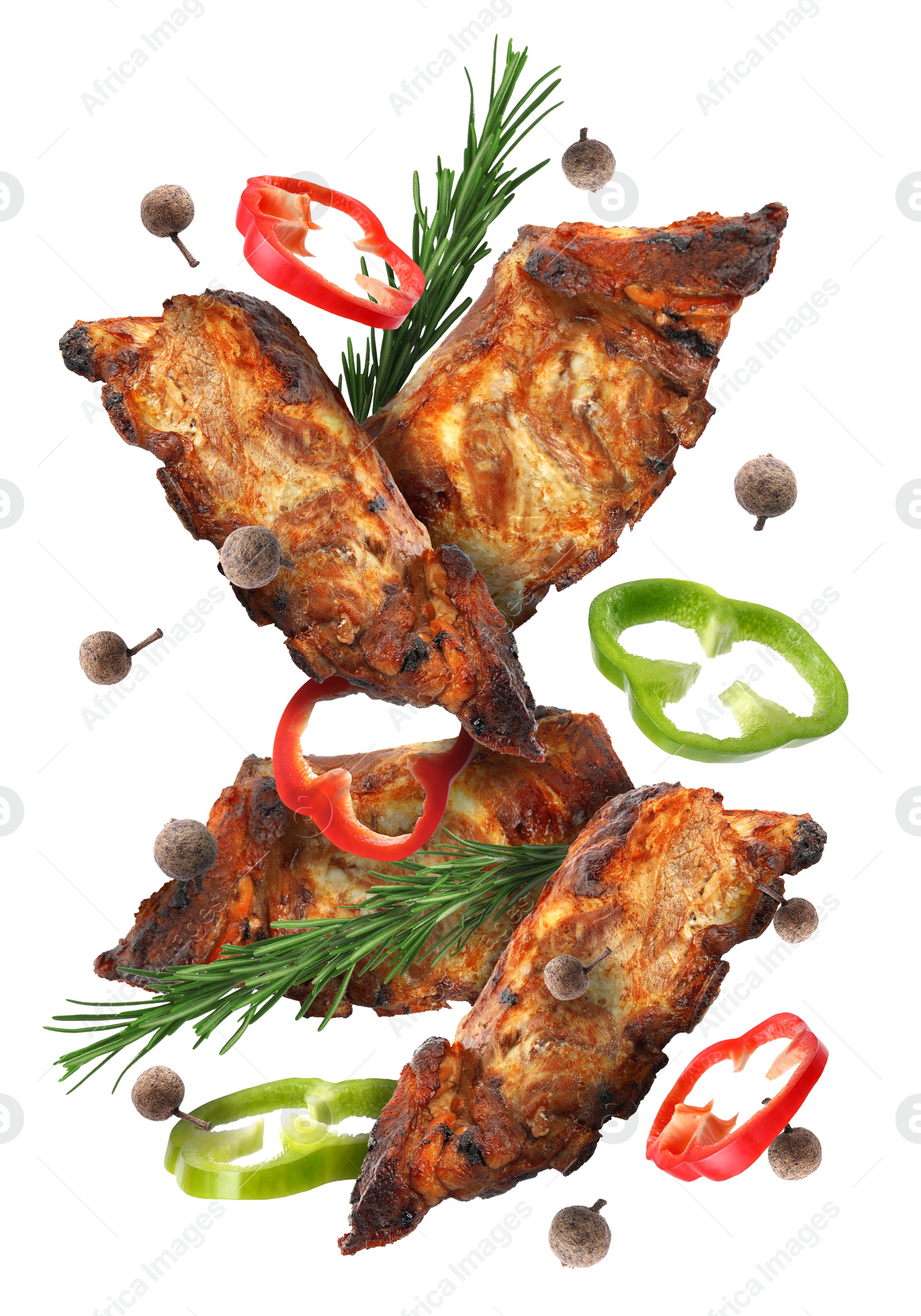 Image of Grilled beef ribs, pepper slices, rosemary and peppercorns in air isolated on white