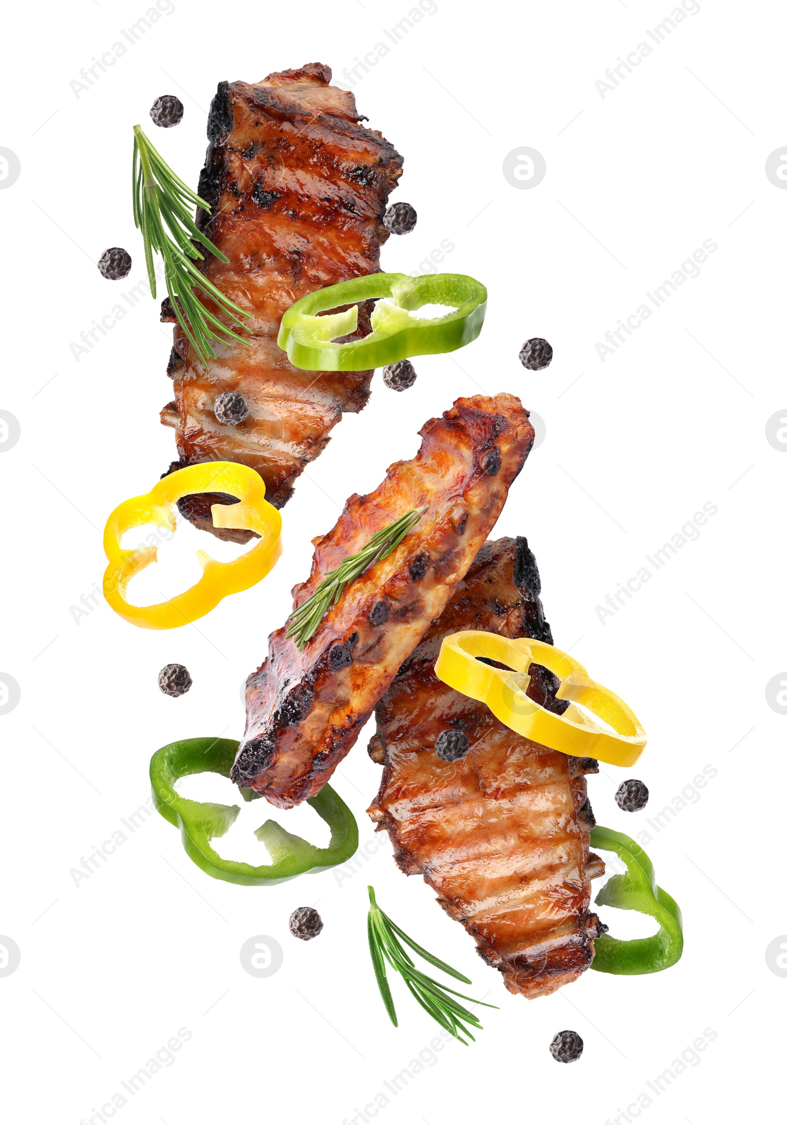 Image of Grilled beef ribs, pepper slices, rosemary and peppercorns in air isolated on white