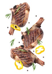 Image of Grilled beef steaks, pepper slices, rosemary and peppercorns in air isolated on white