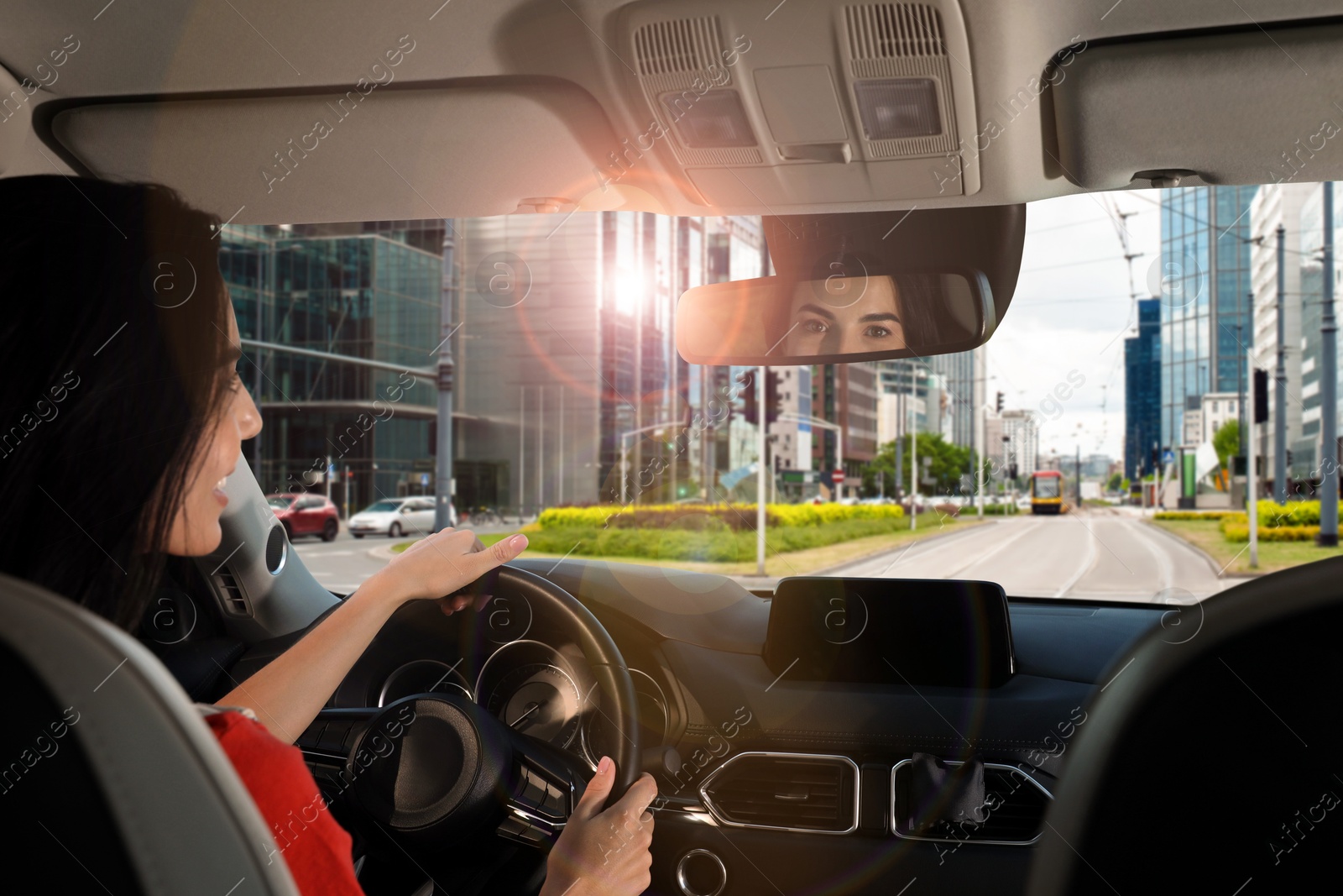 Image of Woman holding hands on steering wheel. Driving car