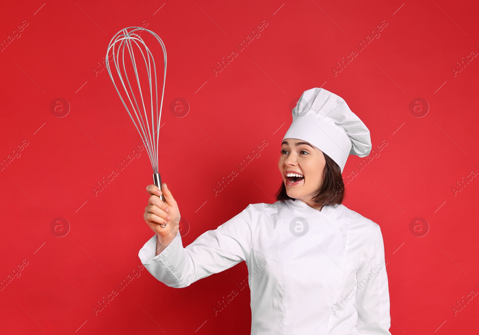 Image of Happy pastry chef with big whisk on red background