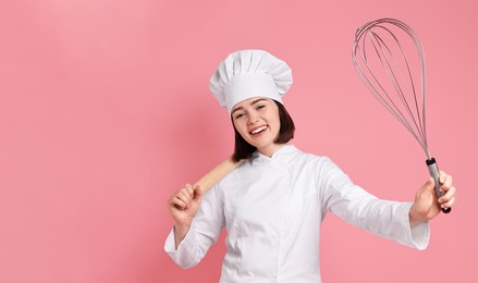 Image of Happy pastry chef with big whisk and rolling pin on pink background. Banner design