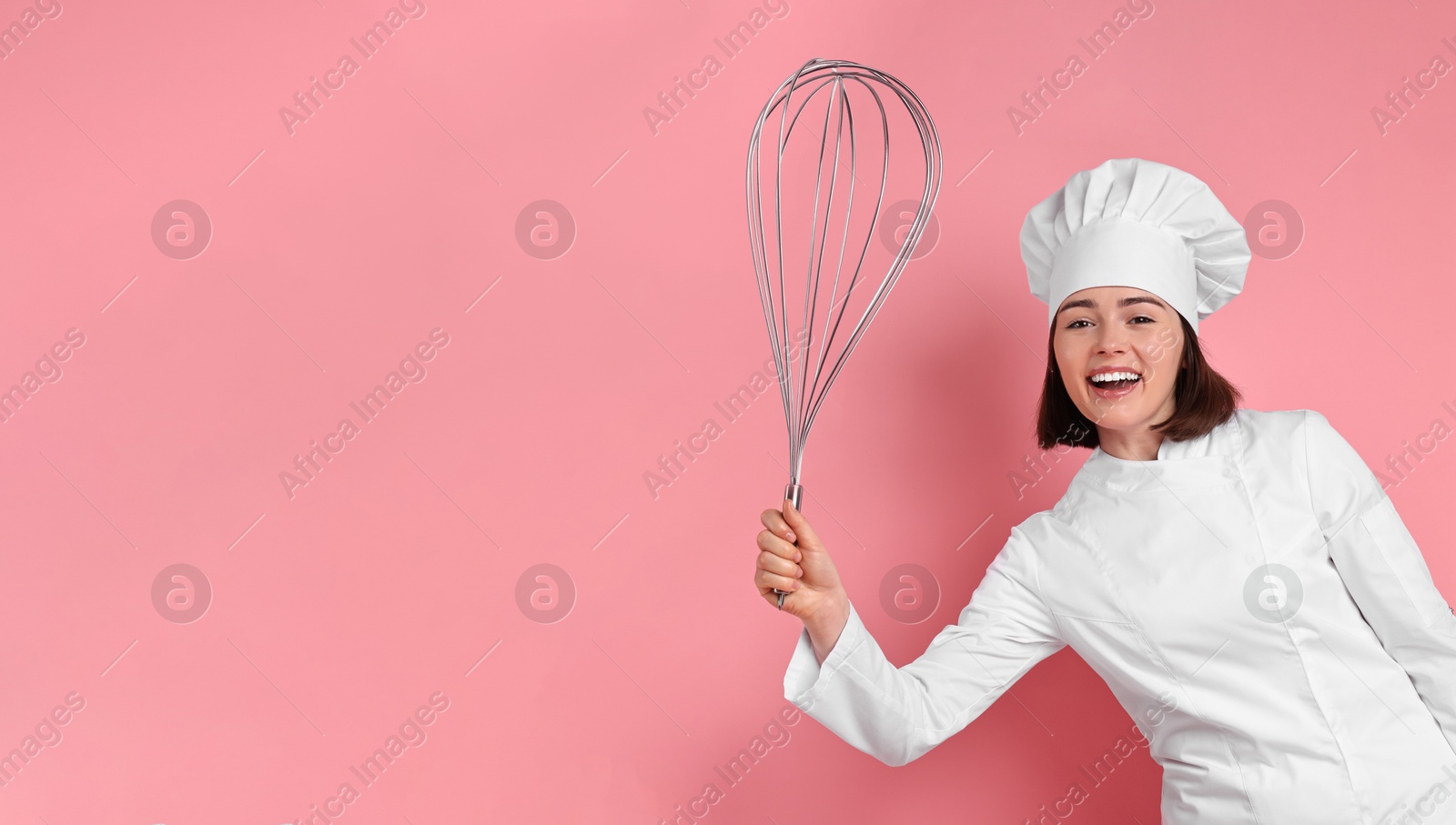 Image of Happy pastry chef with big whisk on pink background. Banner design