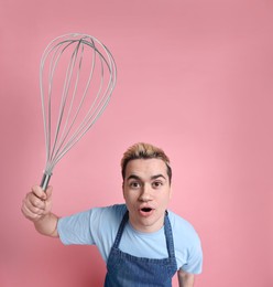Image of Pastry chef with big whisk on pink background