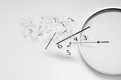 Image of Numerals and hands flying away from clock on white background. Time is running out