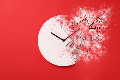 Image of Analog clock dissolving on red background. Time is running out