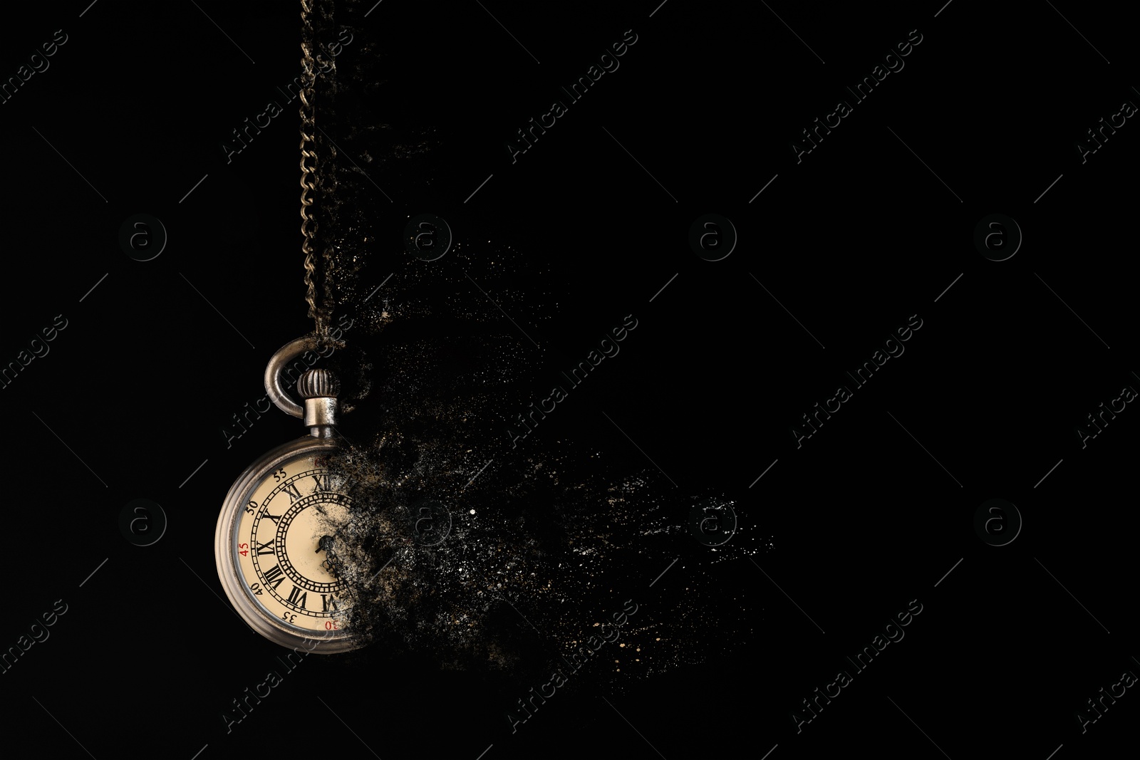 Image of Vintage pocket watch with chain dissolving on black background. Fleeting time