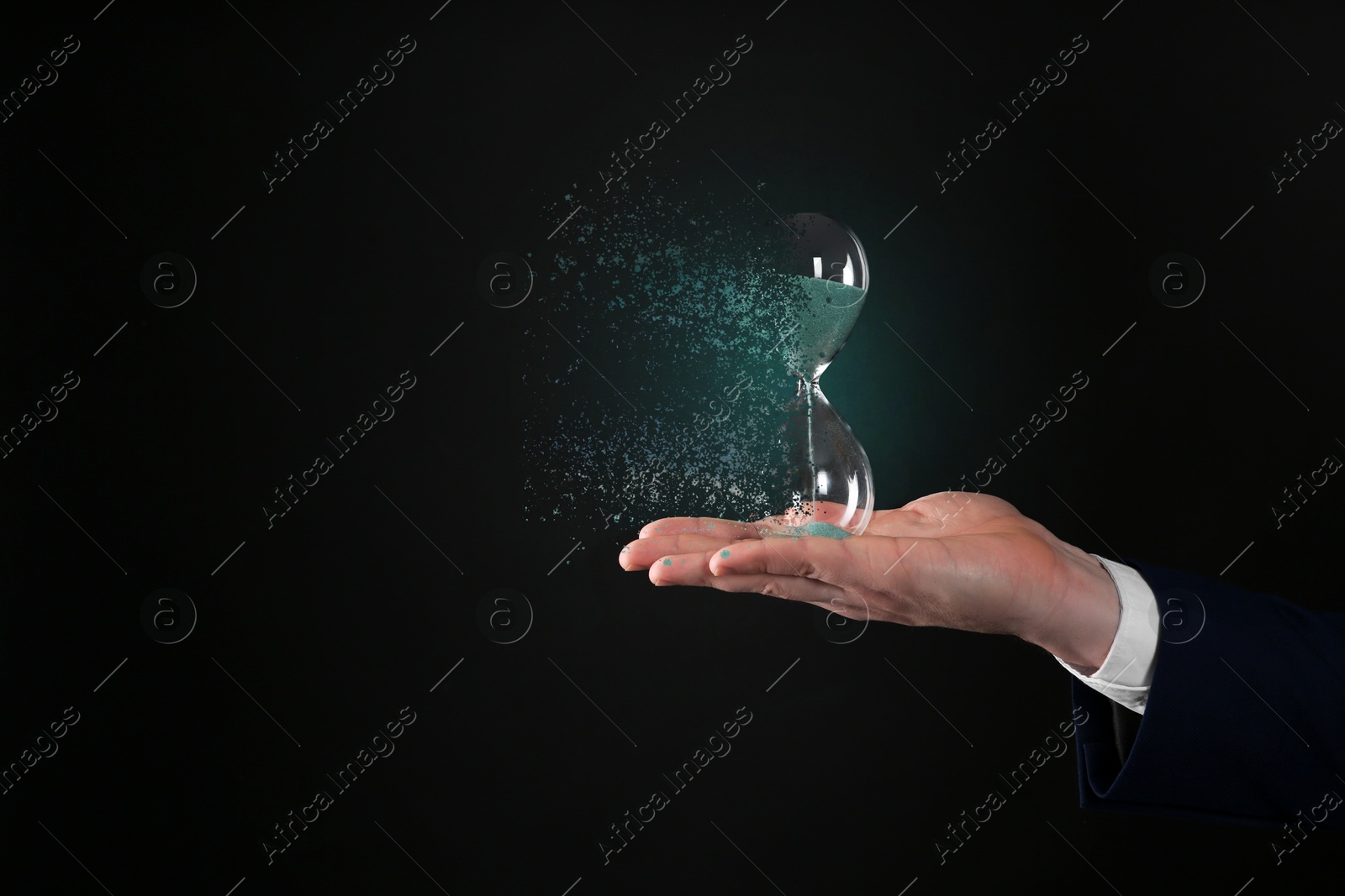 Image of Businessman holding dissolving hourglass on black background, closeup. Time is running out