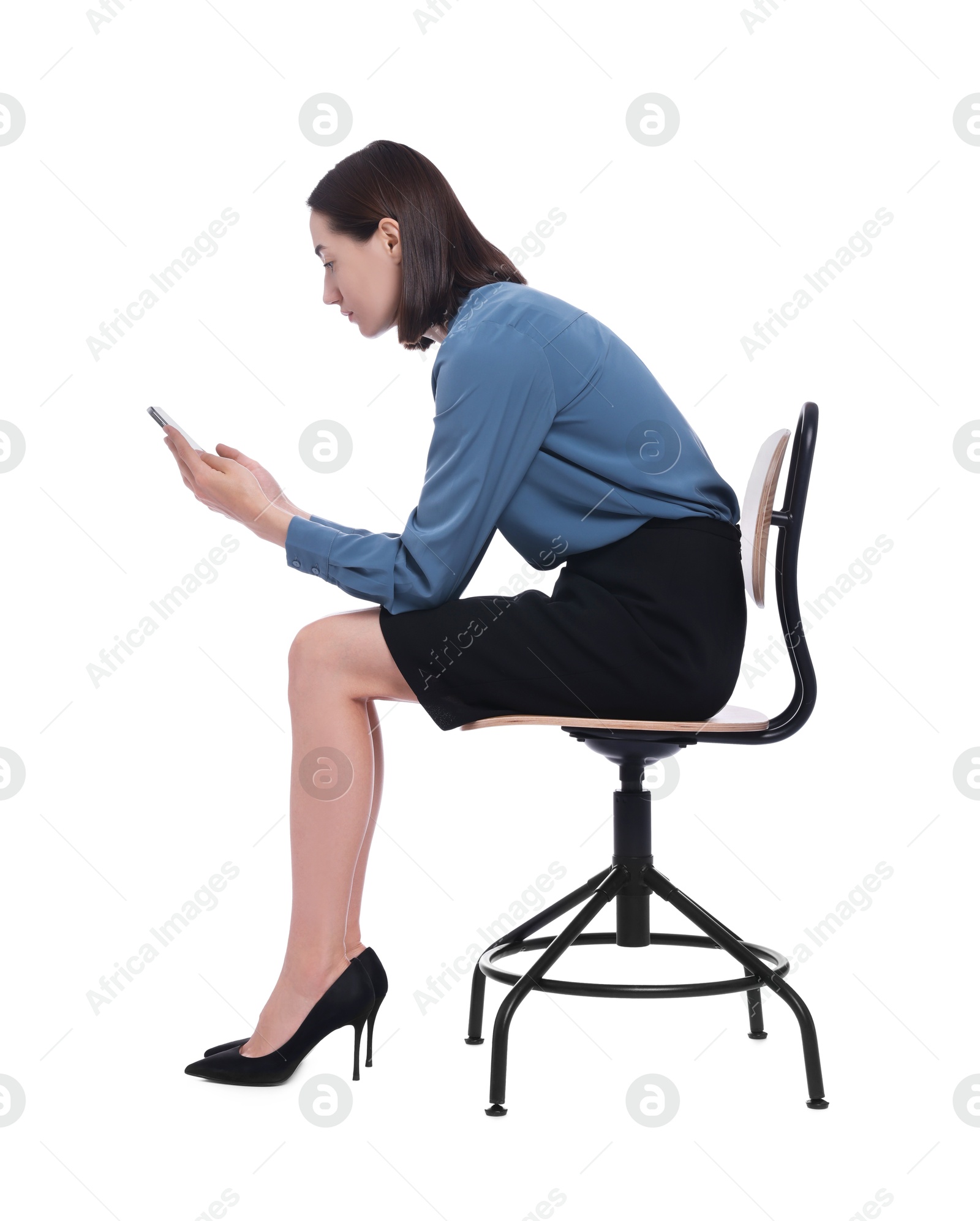 Photo of Woman with poor posture sitting on chair and using smartphone against white background