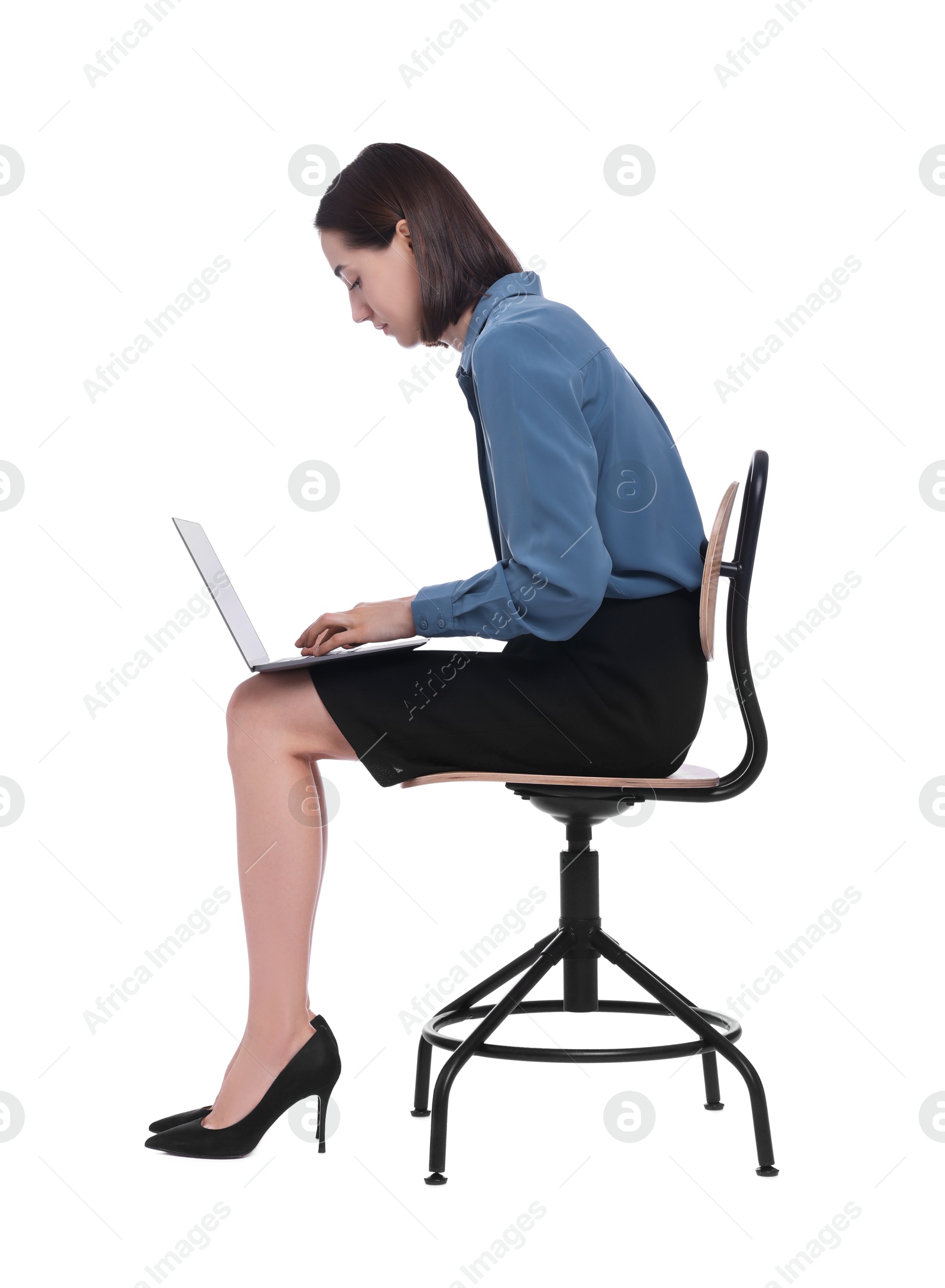 Photo of Woman with poor posture sitting on chair and using laptop against white background