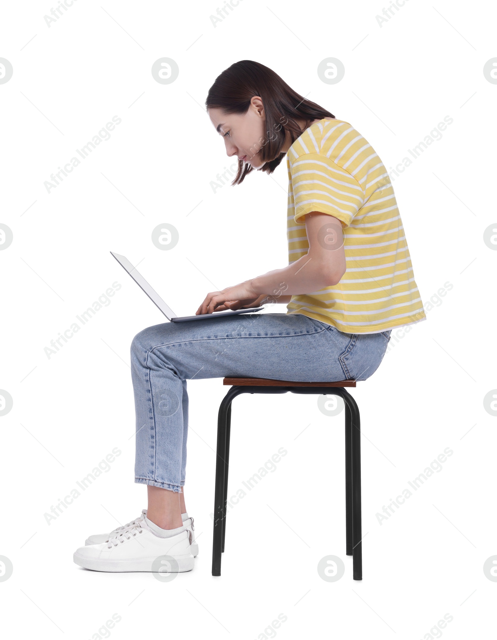 Photo of Woman with poor posture sitting on chair and using laptop against white background