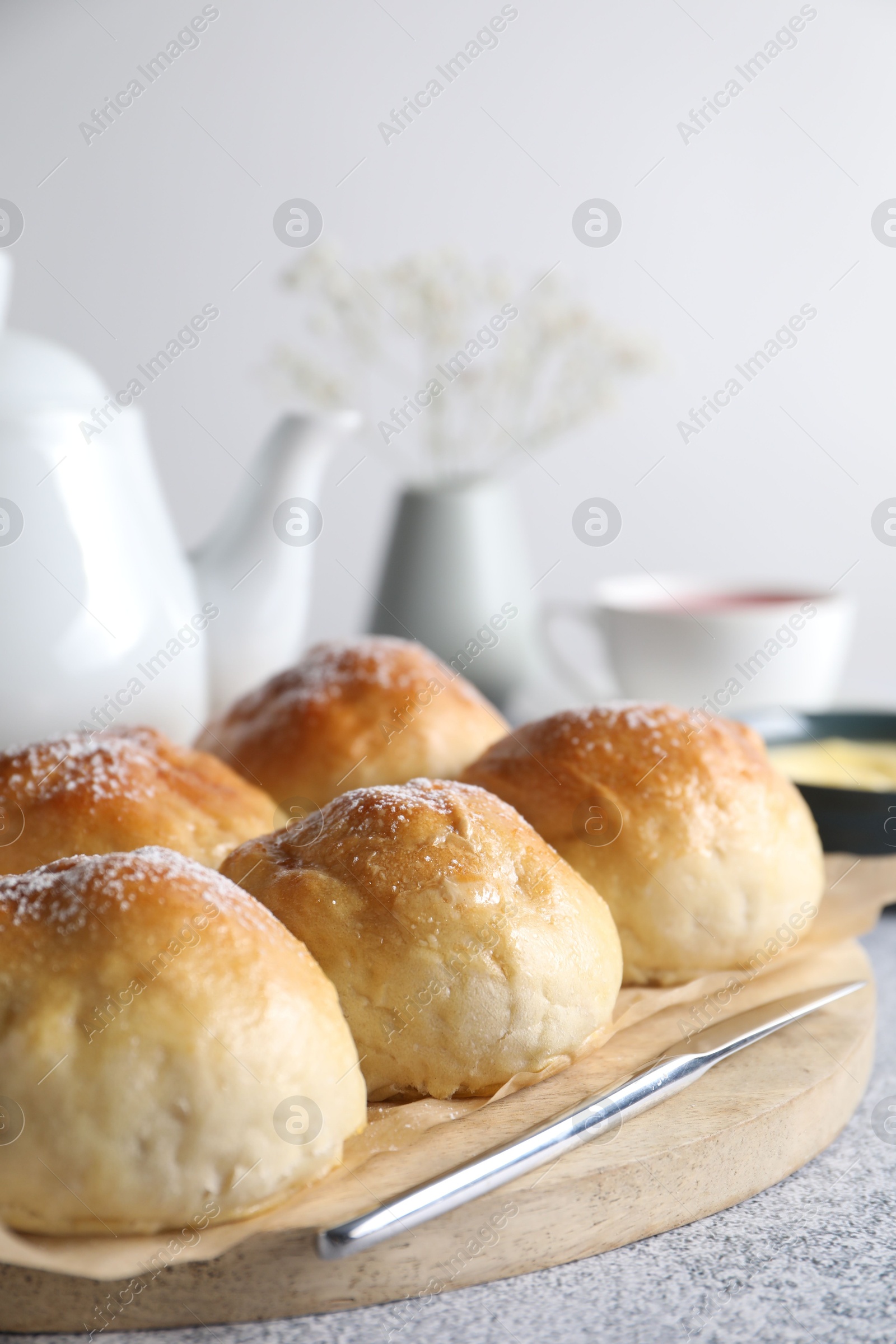 Photo of Delicious dough balls and tea on grey table, selective focus