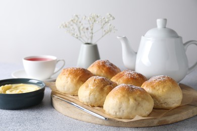 Delicious dough balls, sauce and tea on grey table, closeup