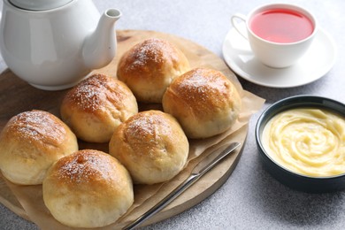 Delicious dough balls, sauce and tea on grey table, closeup