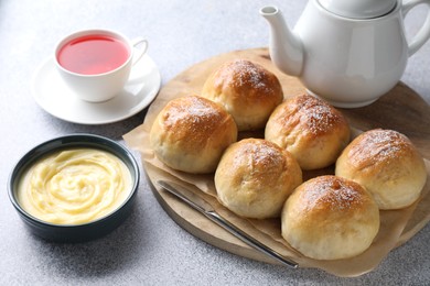 Delicious dough balls, sauce and tea on grey table, closeup