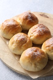 Delicious dough balls on grey table, closeup