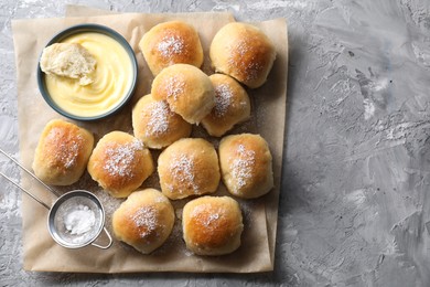 Delicious dough balls and sauce on grey table, top view