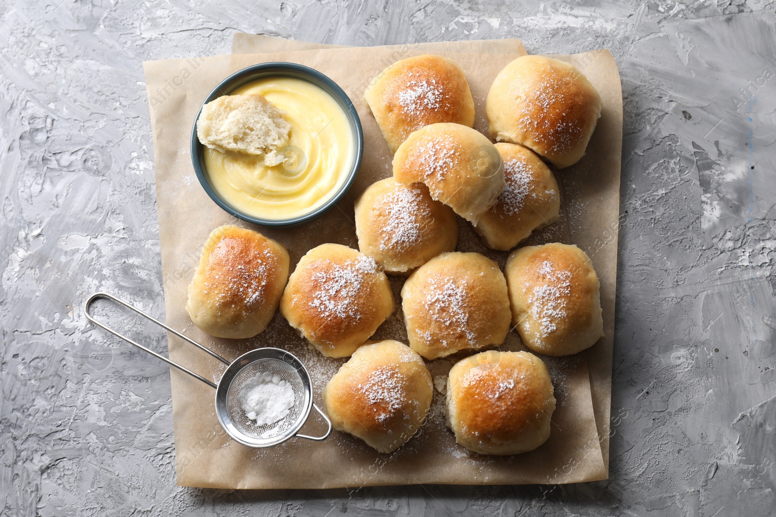 Photo of Delicious dough balls and sauce on grey table, top view