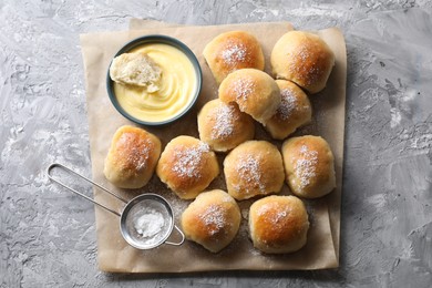 Delicious dough balls and sauce on grey table, top view