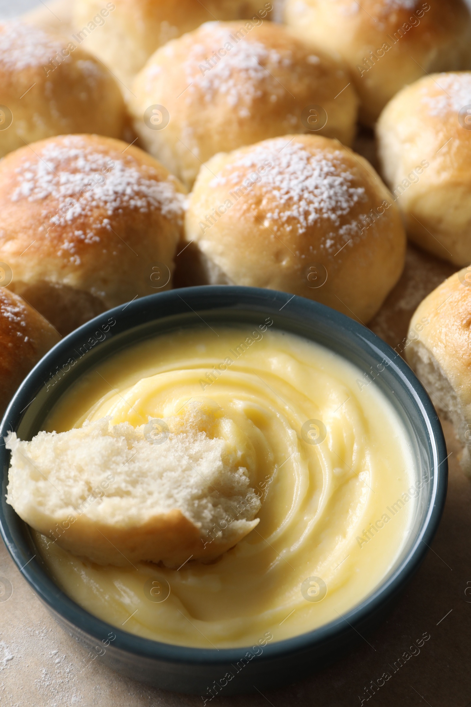 Photo of Delicious dough balls with sauce on table, closeup