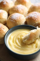 Delicious dough balls with sauce on table, closeup