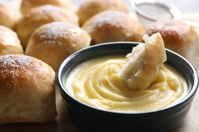 Photo of Delicious dough balls with sauce on table, closeup