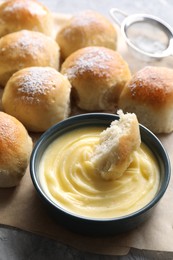 Delicious dough balls and sauce on grey table, closeup