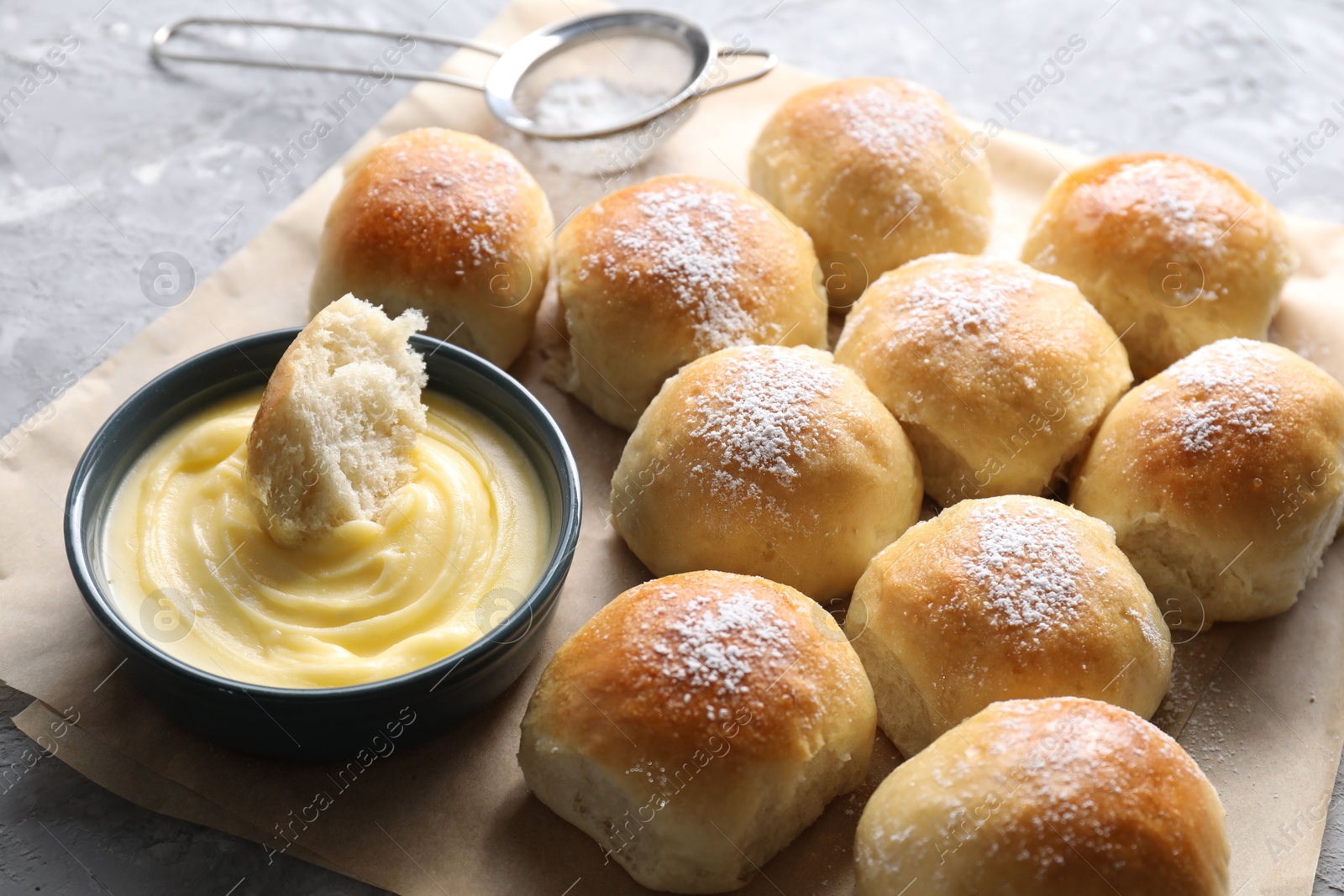 Photo of Delicious dough balls and sauce on grey table, closeup