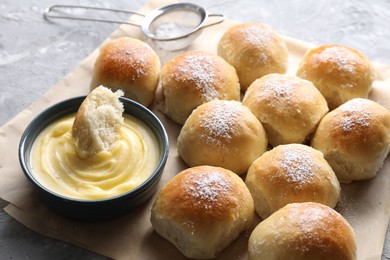 Photo of Delicious dough balls and sauce on grey table, closeup