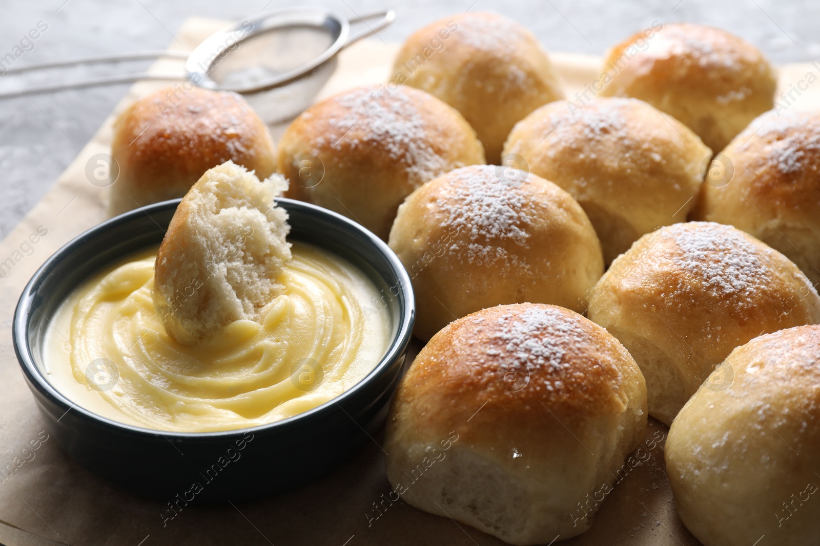 Photo of Delicious dough balls and sauce on grey table, closeup